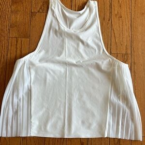 Size 4 white lululemon ruffle tank.  Excellent condition!